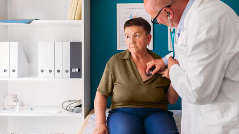 A doctor is listening to a persons heart and breathing.