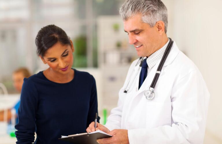 Senior doctor checking patient's test result