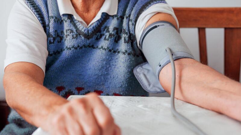 a man is getting his blood pressure taken with a cuff
