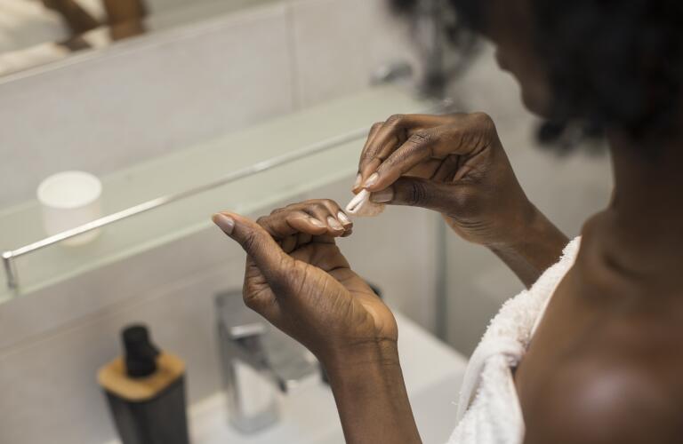 Woman removing her nail polish