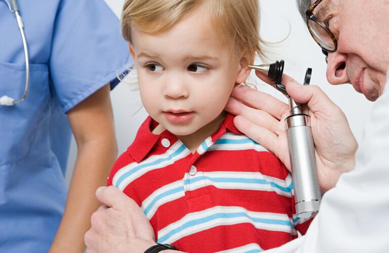 Doctor looking in boys ear