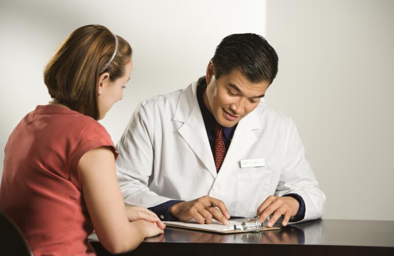 Male doctor consulting with female doctor
