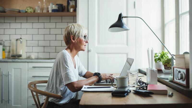 A woman is researching on a laptop.