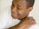man holding aching shoulder 