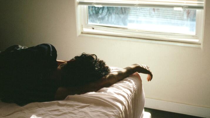A person laying on a bed