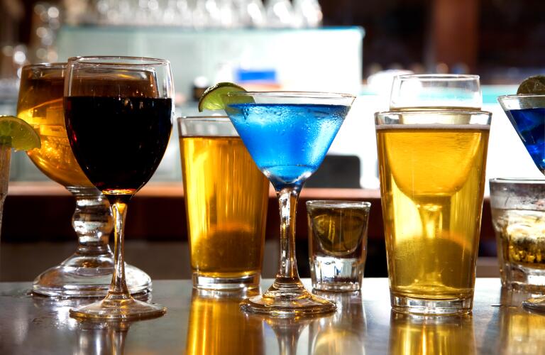 mixture of wine, liquor, beer glasses on bar