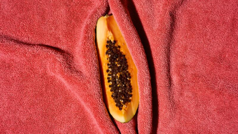 Half a papaya shows fruit seeds inside.