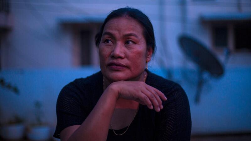 there is a woman with smoldering multiple myeloma standing outside at dusk