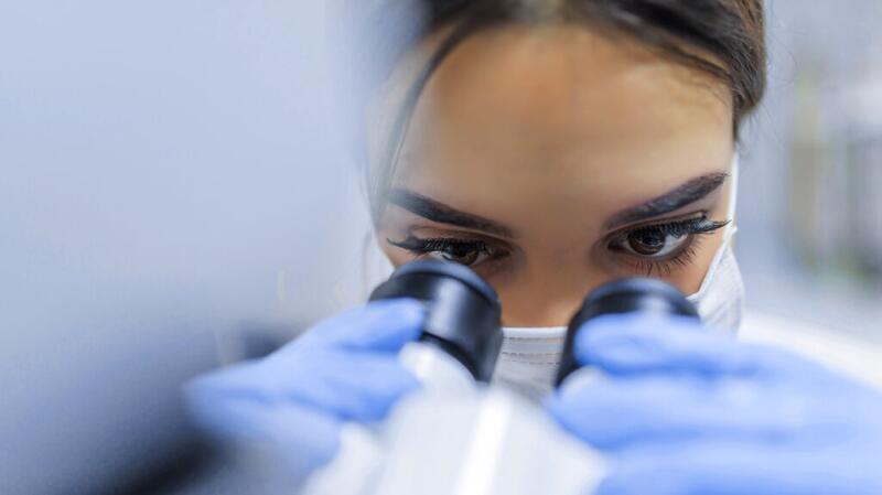 a doctor is using a microscope