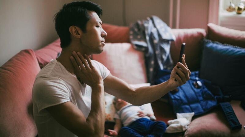 A man feeling his neck