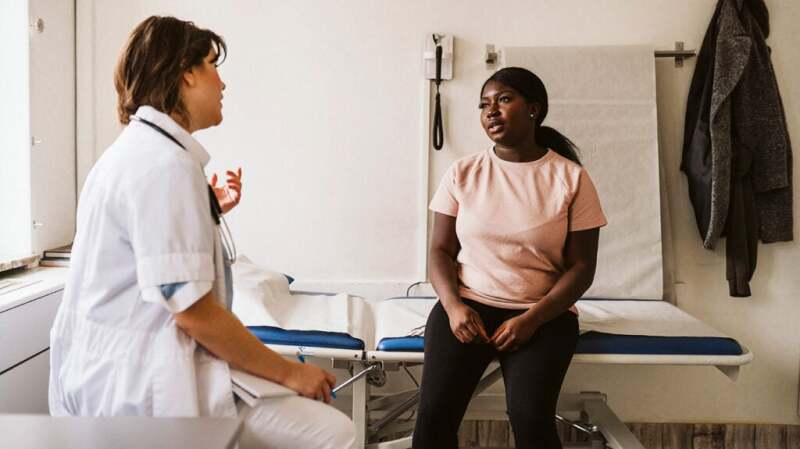 Female talking with a doctor in a doctor's office
