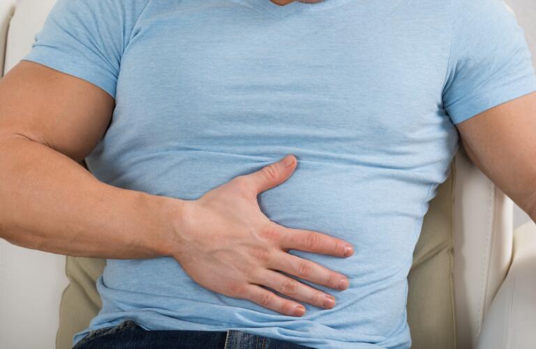 Man holding stomach
