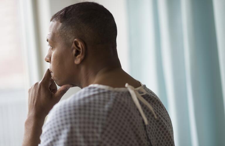 concerned male patient in dressing gown waiting for doctor