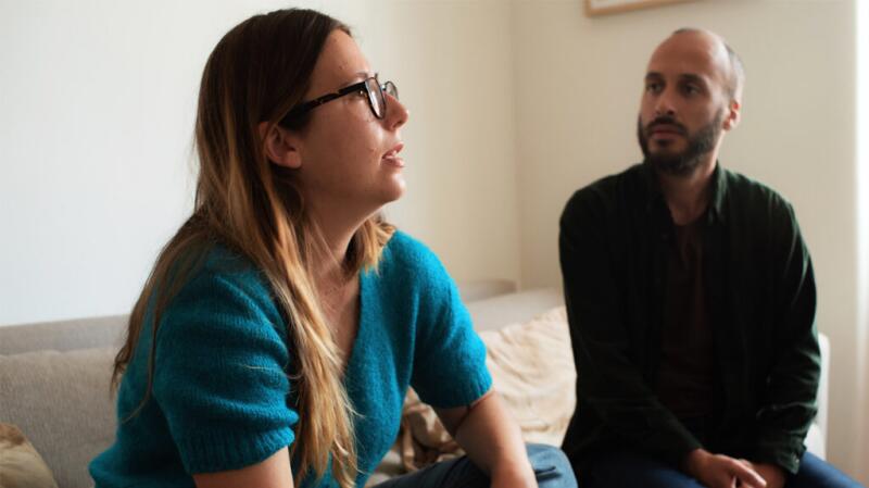man looking at woman as she speaks