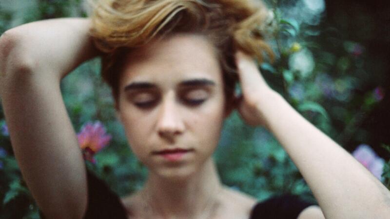 Out of focus image of a female holding her hair