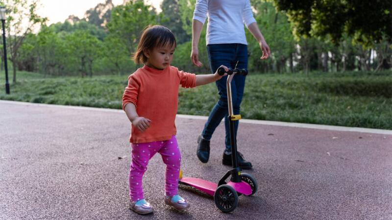 Mother and toddler walking in the park