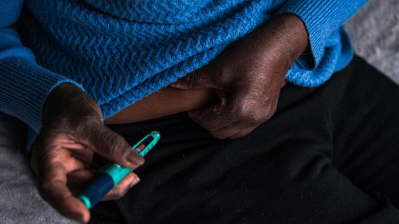 a person is injecting insulin