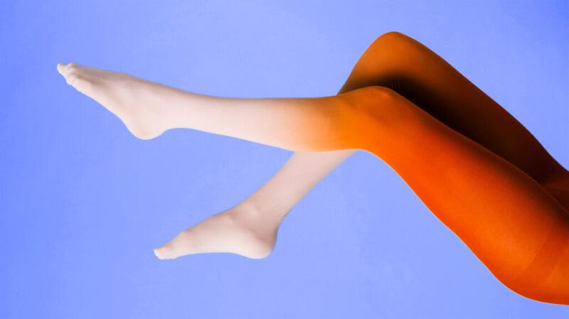 Close up of red legs against a purple background