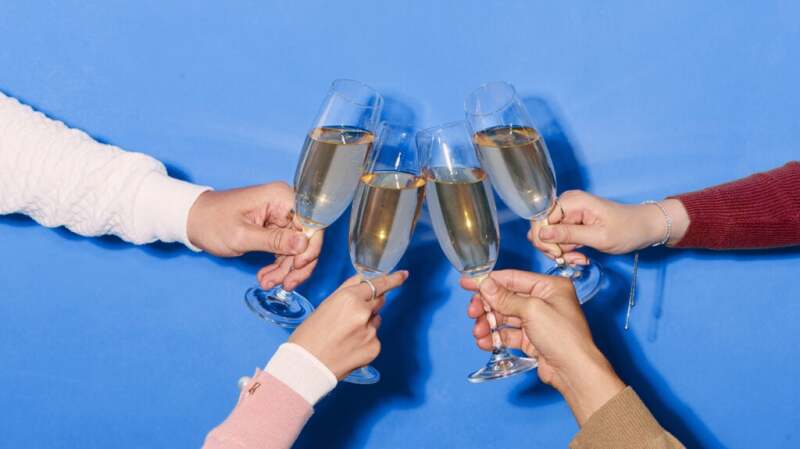 4 people toasting with glasses of champagne