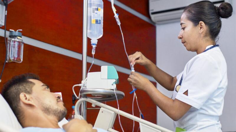 a nurse is setting up an IV line