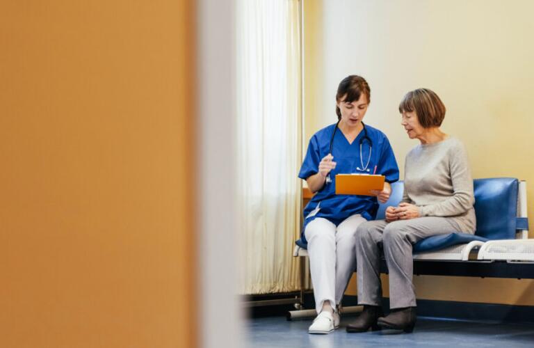 a doctor is talking to a woman in a hospital hallway