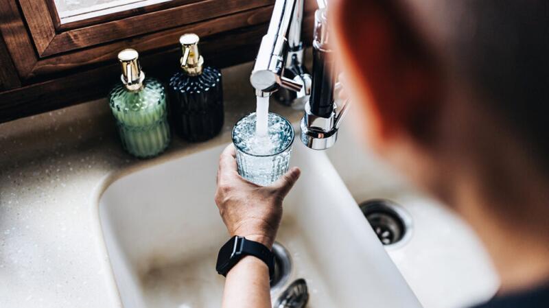 A man filling a glass with water