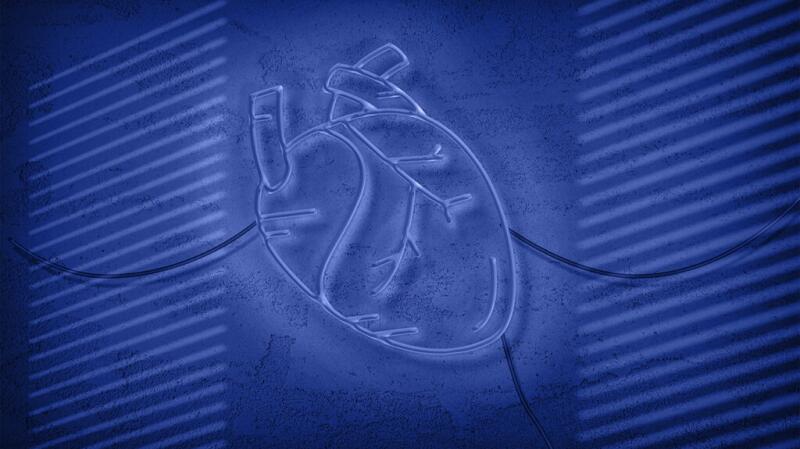 There is an LED heart sign against a purple background.