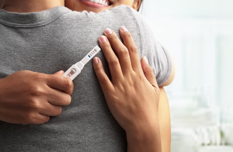 Joyful couple with positive pregnancy results