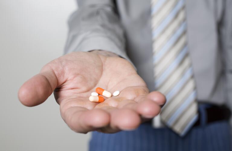 male holding pills