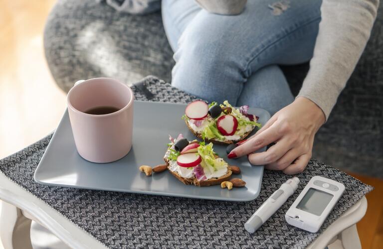 Young diabetic woman having breakfast at home