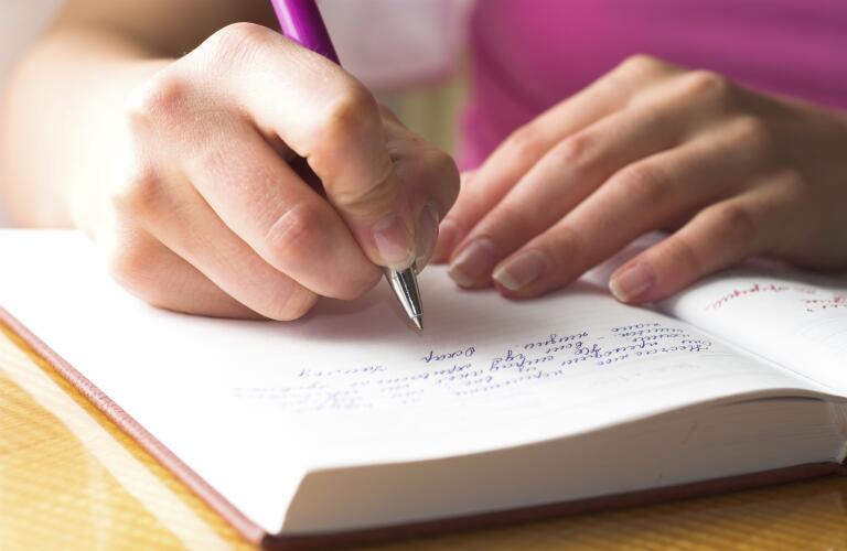woman writing in journal