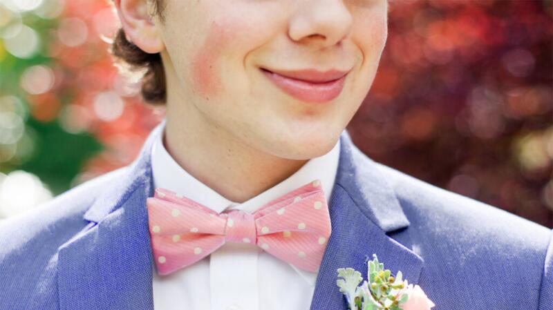 A person in a smart outfit is blushing.