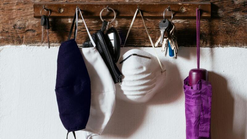 Different types of masks hanging on a hook