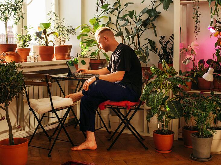 A man is sitting at desk; prolonged sitting can be a risk factor for thrombosis.