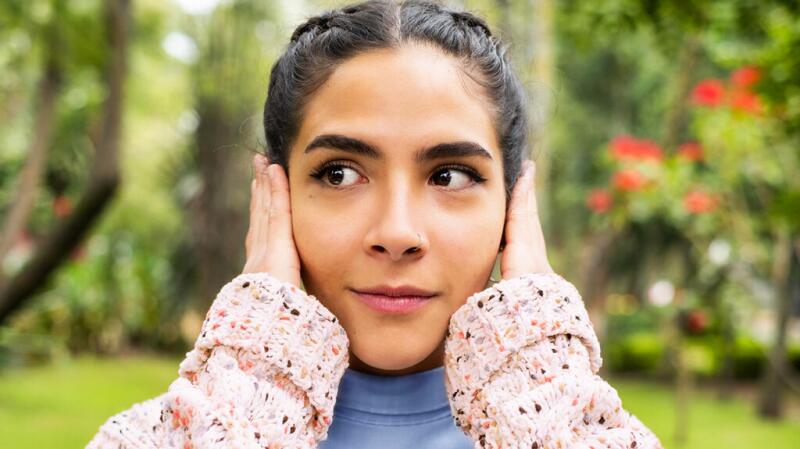 Woman with hands over her ears