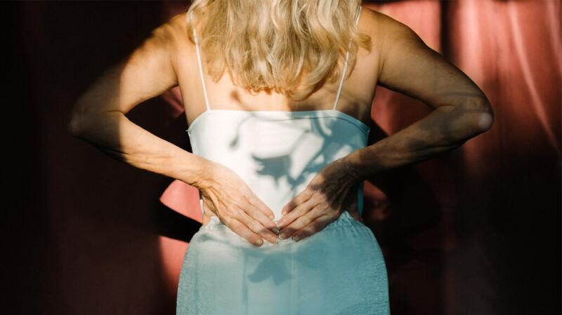 woman holding back