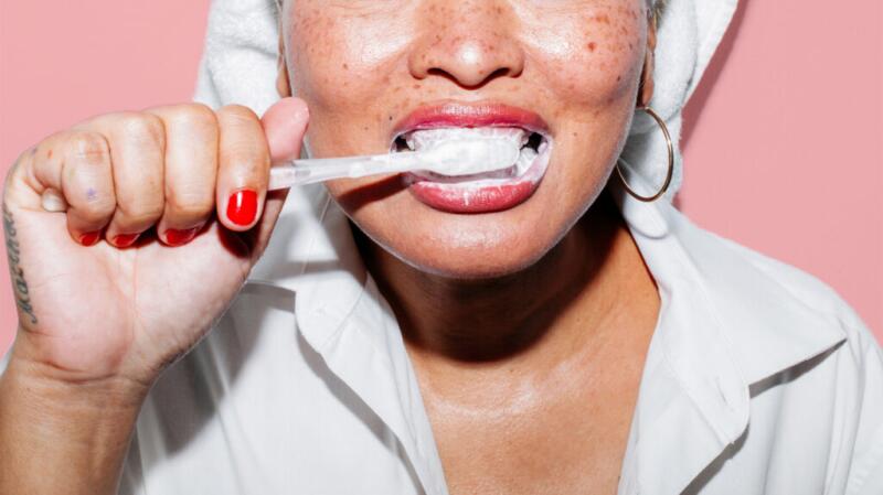 A woman brushing her teeth