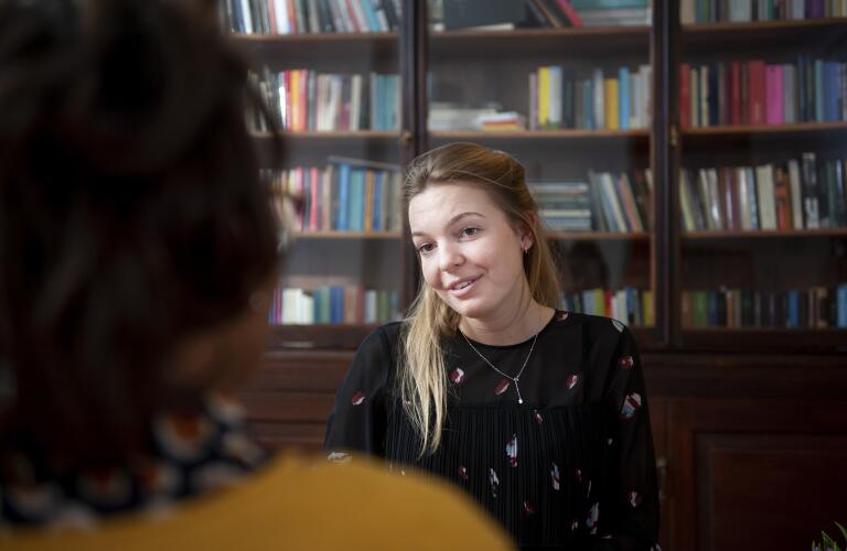 Young Caucasian woman talking to counselor in office