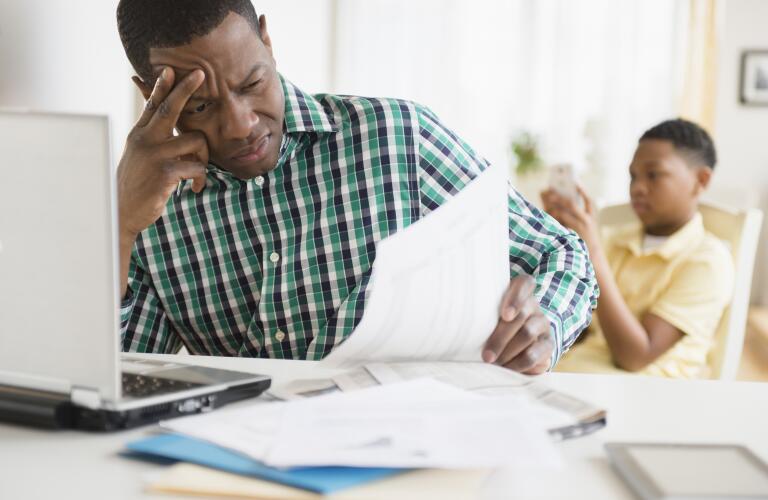 frustrated father paying bills online