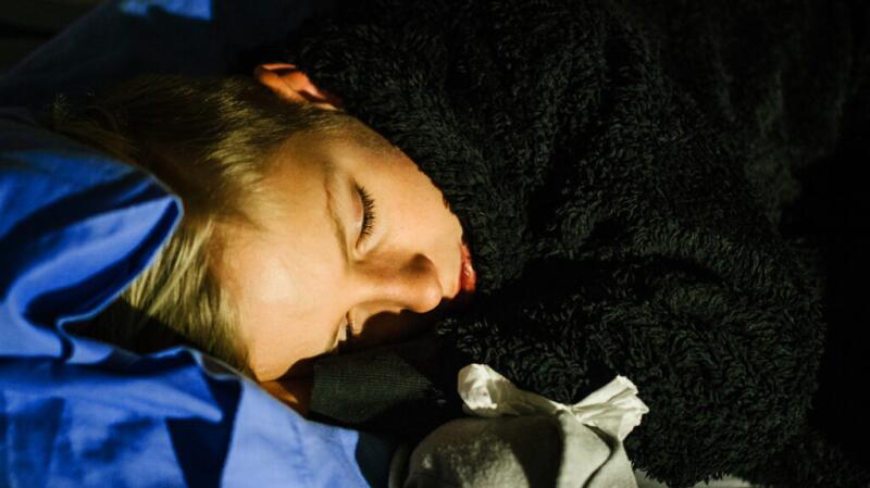 a young boy is resting with a cold