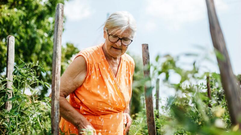 senior woman outside in a garden