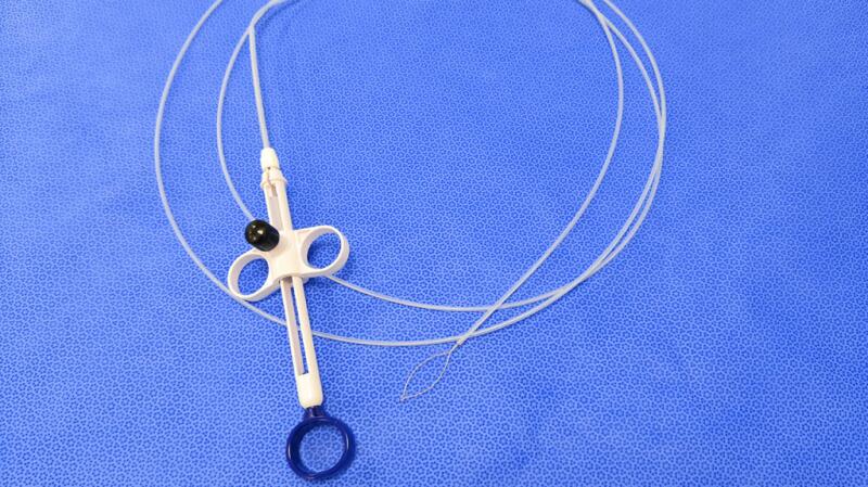 There is an endoscope against a blue background.