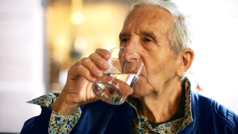 Senior man drinking water