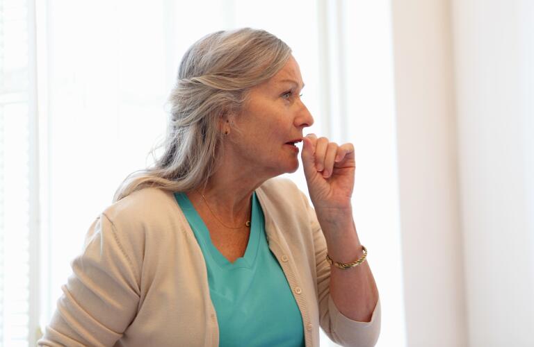 older woman coughing