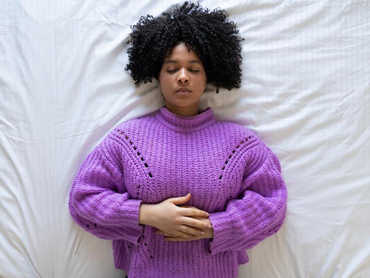 Woman laying down with hands on her stomach