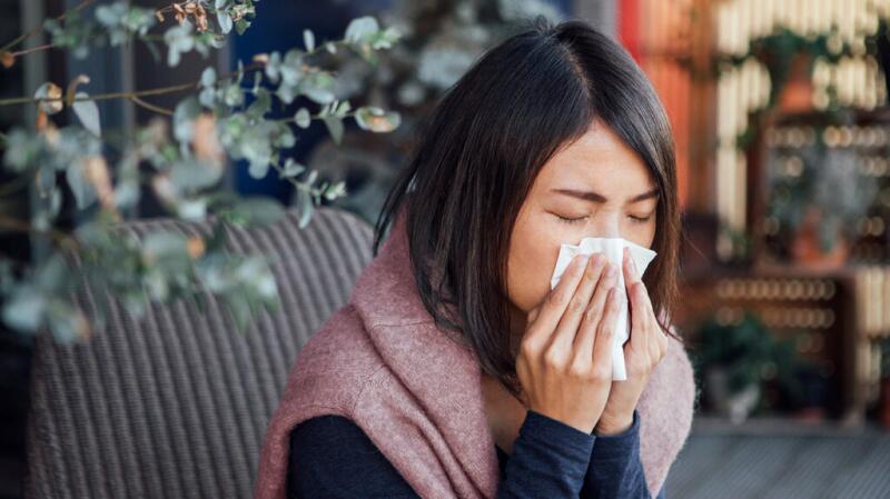 Image of a female blowing her nose