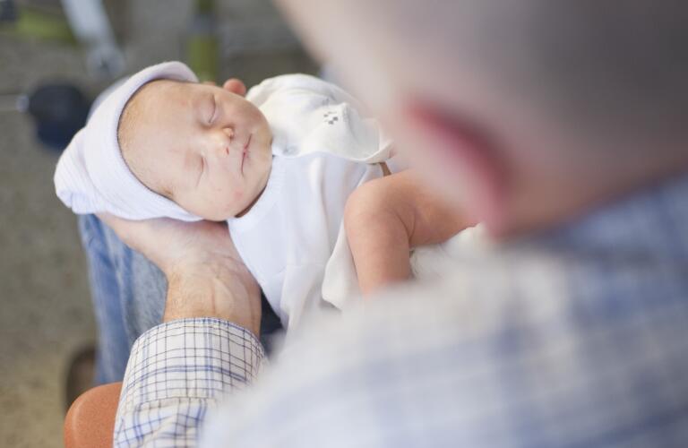 grandfather holding grandchild in hands