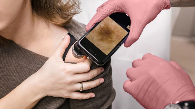 Doctor performing skin exam
