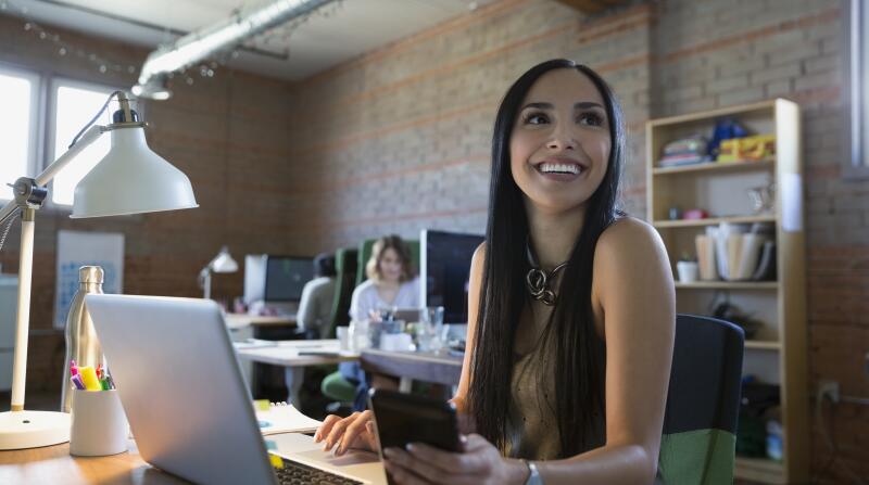 young woman smiling at desk
