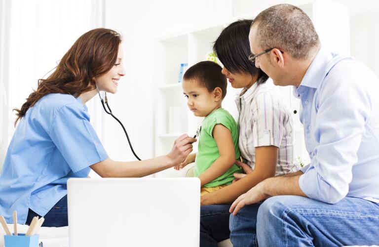 Mixed race family with child visit doctor.